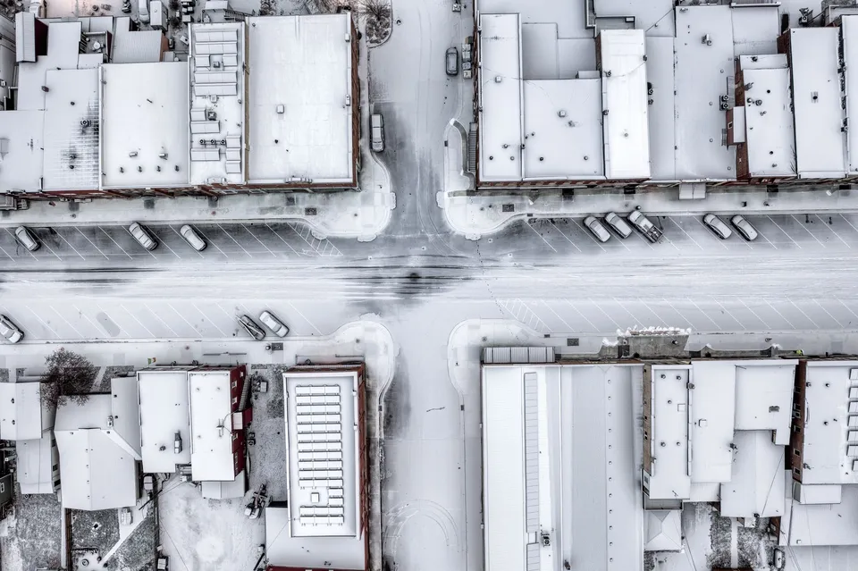 Aerial view of snow-covered streets and buildings in a wintery urban setting in Wabasha, MN.